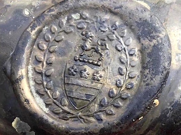 The stars and bars of the Washington family coat of arms is possibly embossed on this bottle recovered from the wreck of the HMS Gloucester.